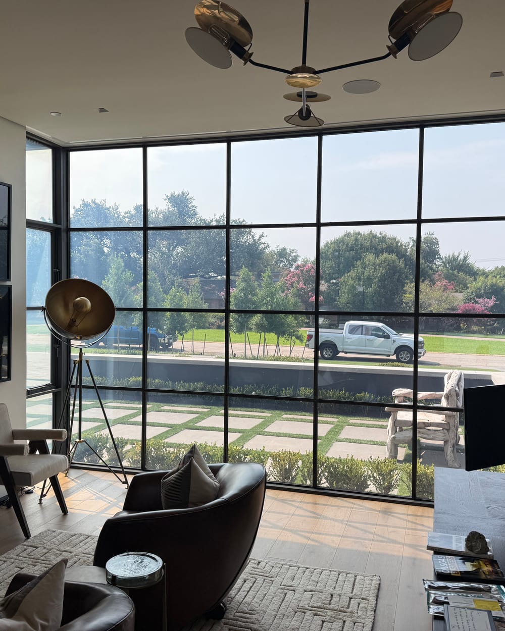 Steel-framed smart glass office wall switched clear for controlled, on-demand transparency